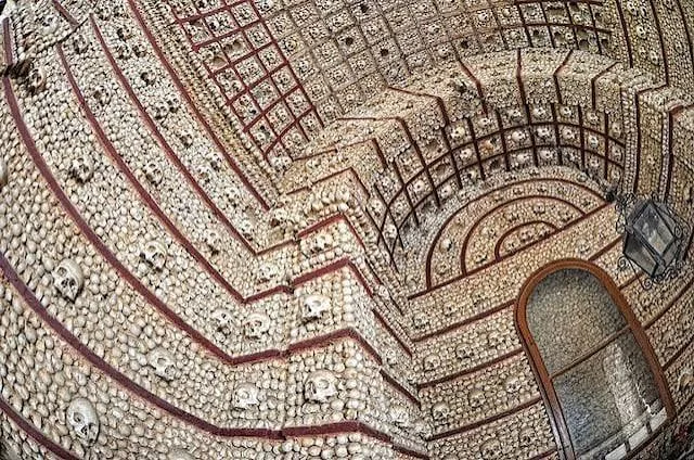 Vaulted ceiling covered in bone patterns inside the Chapel of Bones in Évora