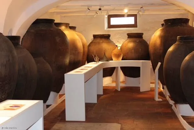 Large clay amphorae in a vaulted room of the MRézio Interactive House Museum