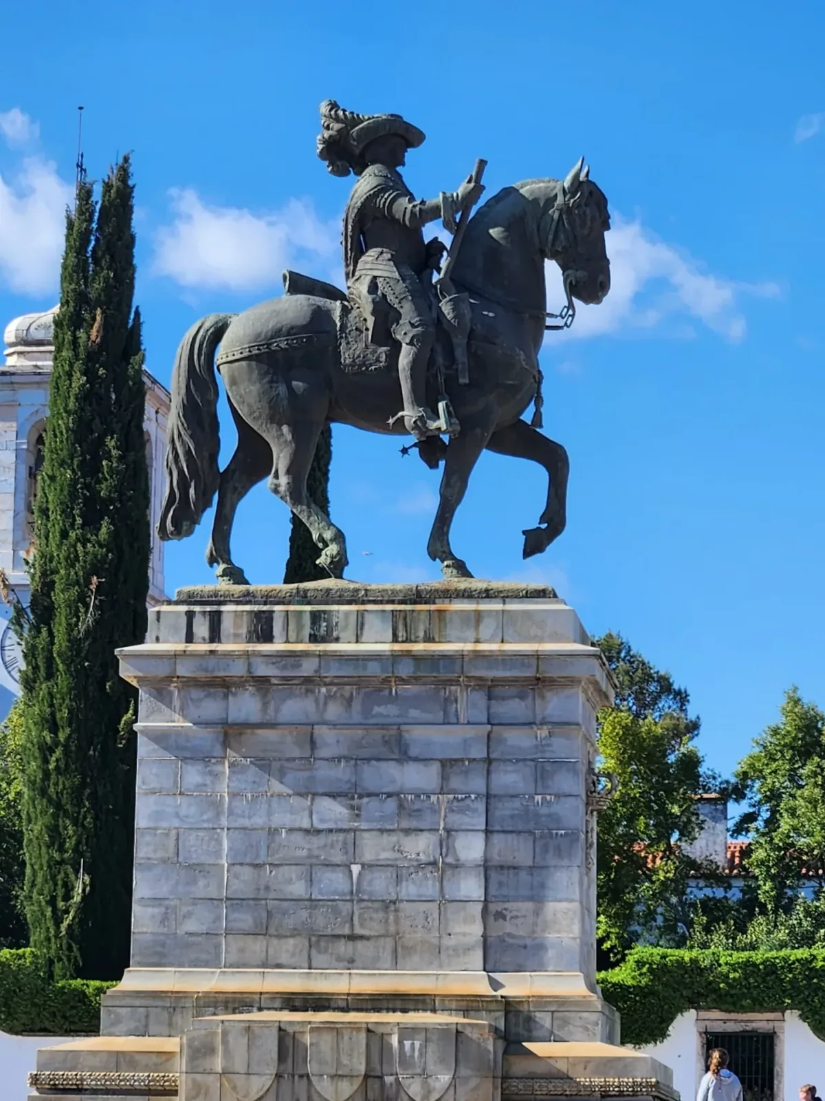 Equestrian statue on a stone pedestal against a blue sky in Vila Viçosa