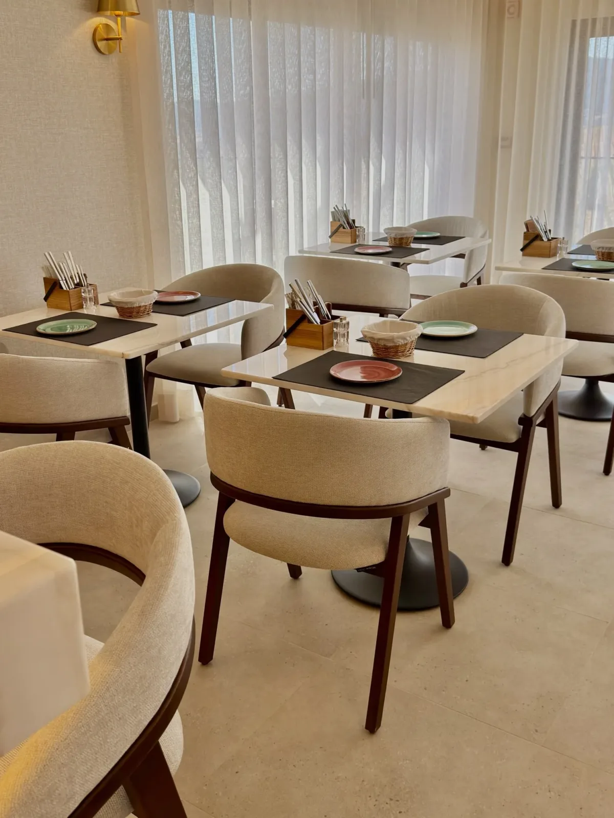 Breakfast room with tables by the sheer curtains
