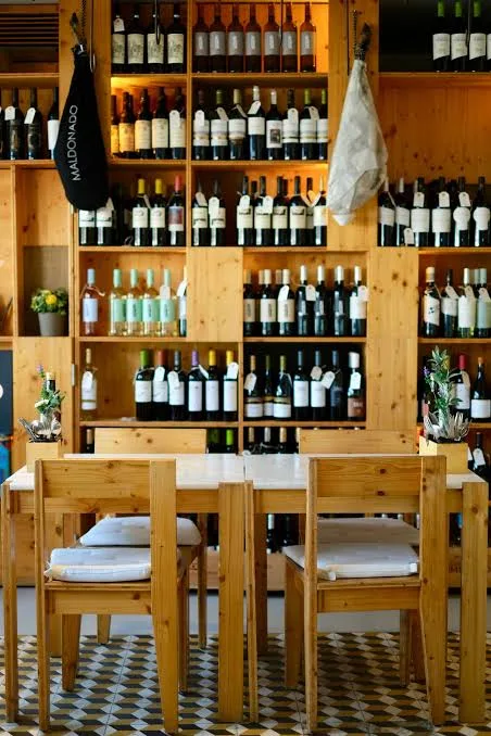 Wine shelves and wooden tables at Alecrim