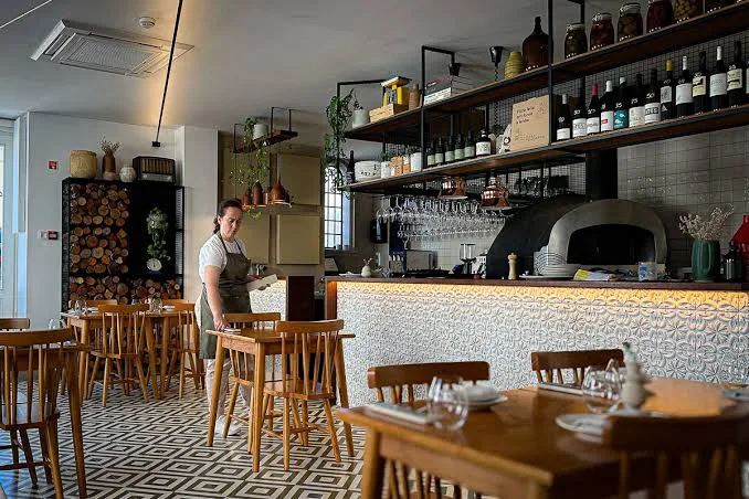 Dining area with an open kitchen and a wood oven at Casa do Gadanha