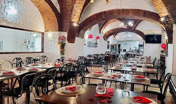 Vaulted brick dining room at O Paço Ducal with set tables