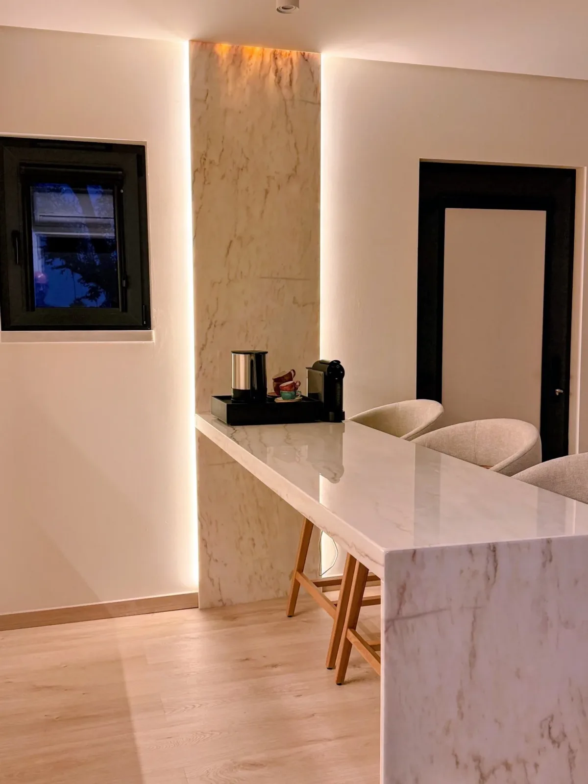 Marble bar with a kettle and coffee machine in the room