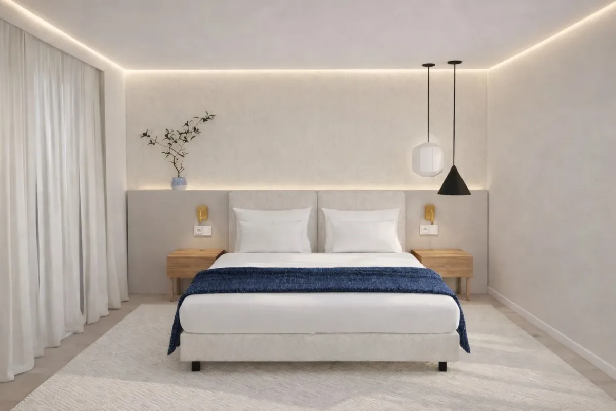 Render de um quarto com cama de casal, manta azul-marinho e dois candeeiros suspensos