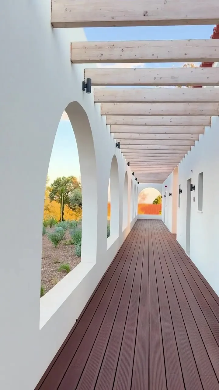 Arched white corridor with a wooden deck, video still
